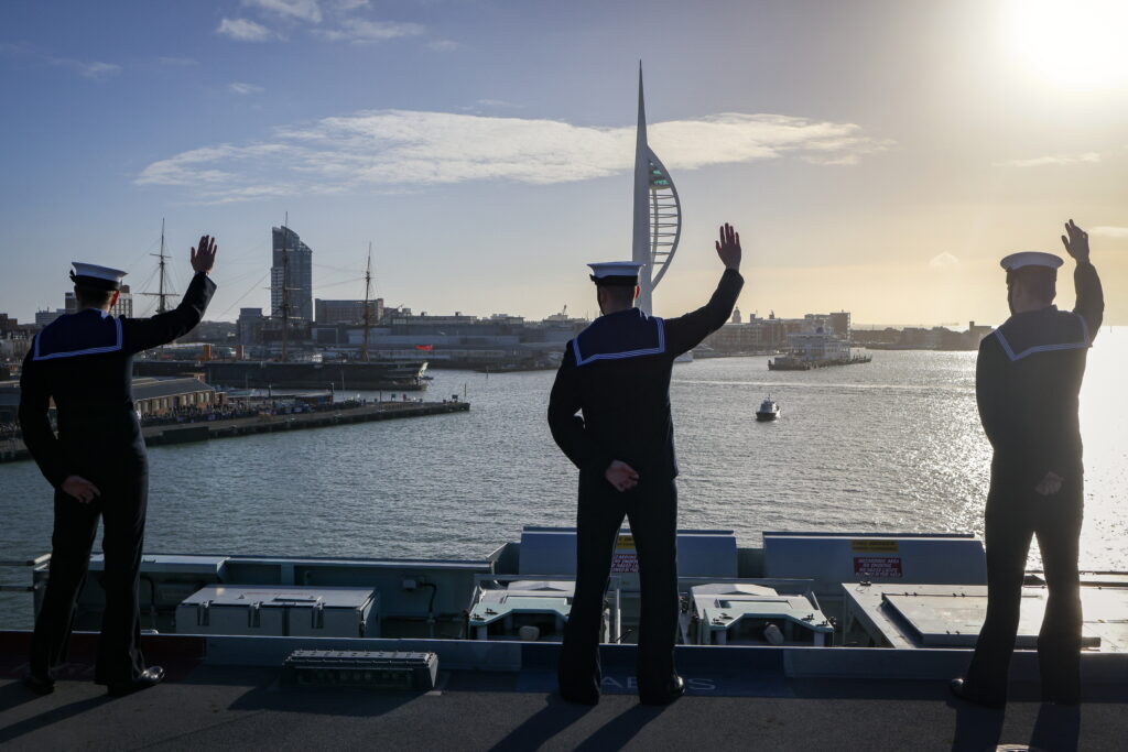 An MoD image of Royal Navy sailors wave as they return home from Westlant
