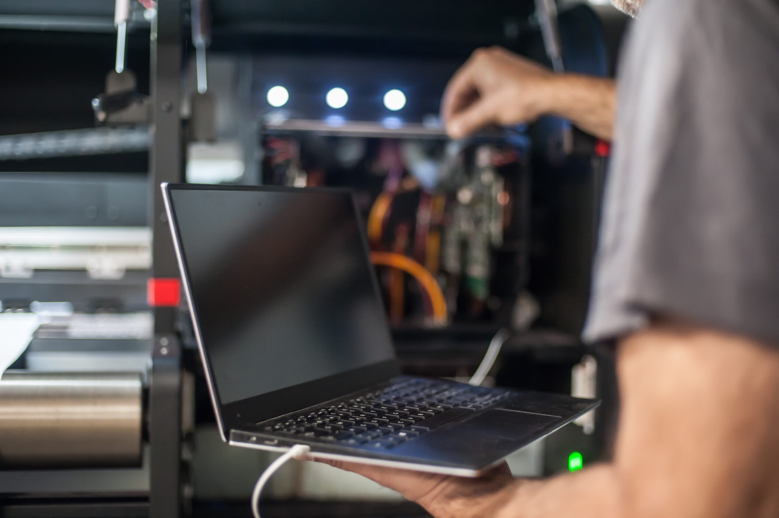 A stock image of systems engineer working on a laptop and testing.