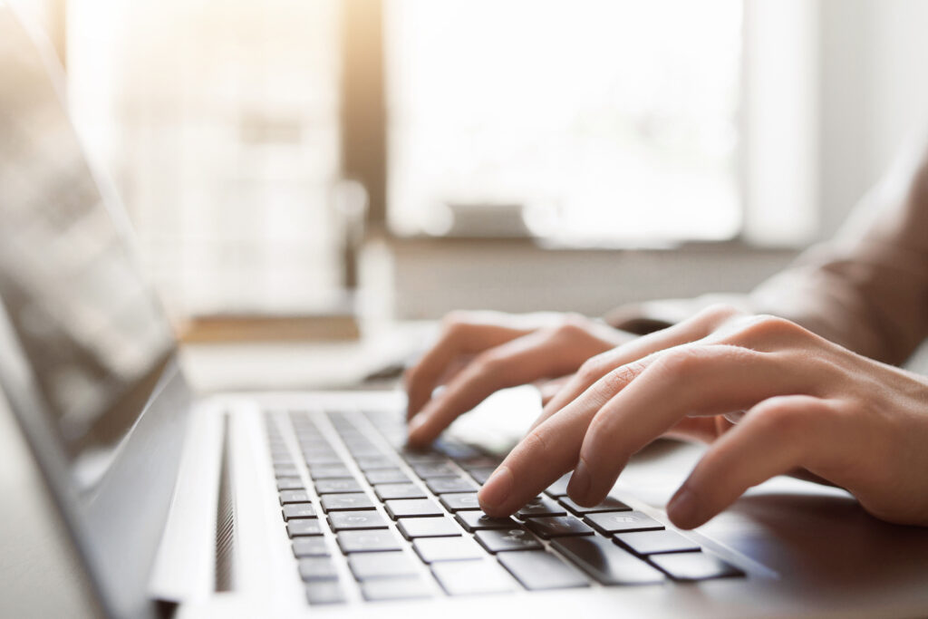A stock image of someone typing on laptop.